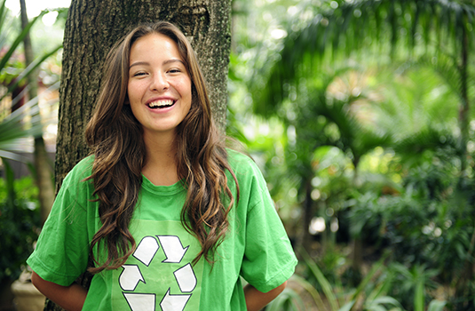 Environmental activist in forest wearing recycle t-shirt